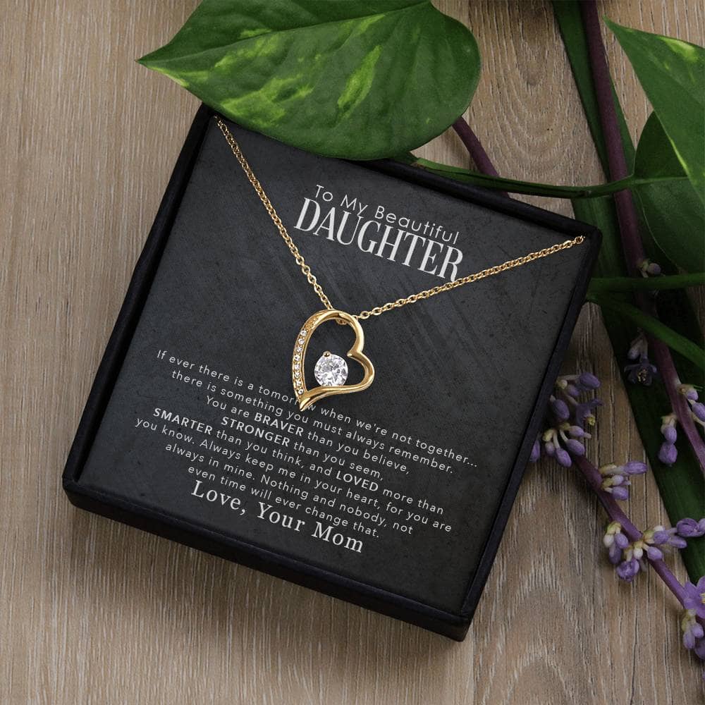 Alt text: "Personalized Daughter Necklace: Heart-shaped pendant with diamond, packaged in luxury box next to plant"