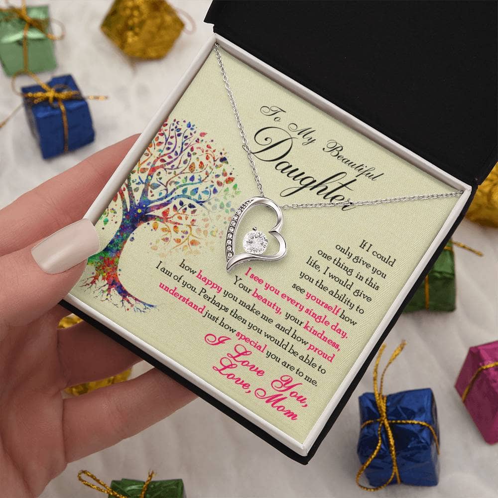 Alt text: "Hand holding 'To My Daughter' necklace in elegant box"
