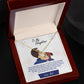 Alt text: "Personalized Daughter Necklace: Gold necklace in a box with diamond pendant, symbolizing parent-daughter bond"