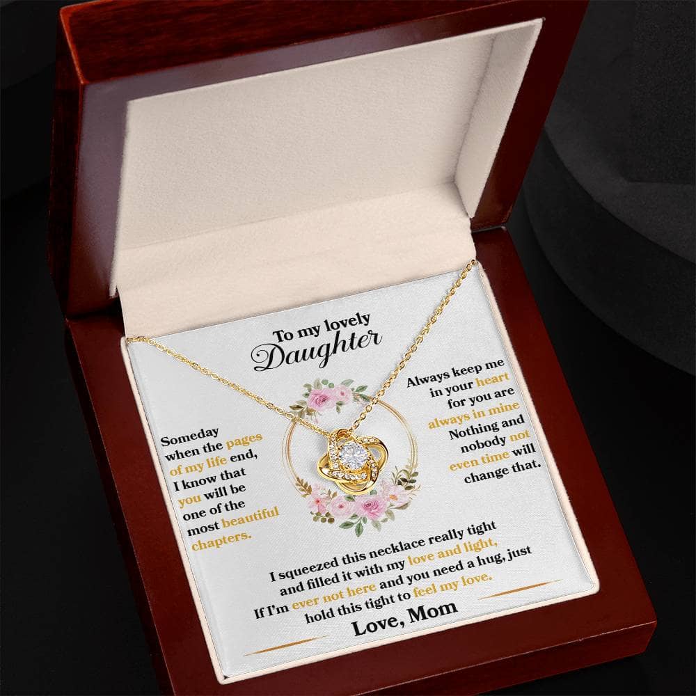 A close-up image of a necklace in a box, reflecting the bond between parent and daughter. The necklace features a heart-shaped pendant adorned with cushion-cut cubic zirconia. The adjustable chain offers comfort and adaptability. The necklace comes in a mahogany-style polished box with LED lights, creating an unforgettable gifting experience.