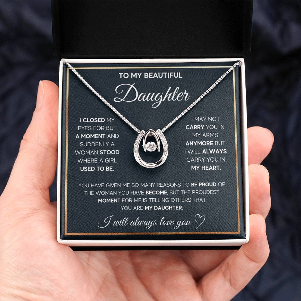 A hand holding a Personalized Daughter Necklace in a box, symbolizing love and bond.