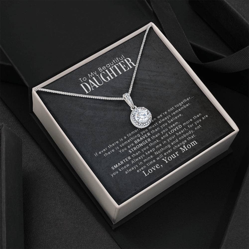 Alt text: "Personalized Daughter Necklace in a mahogany-style box with LED lighting, showcasing a dazzling cushion-cut cubic zirconia pendant."