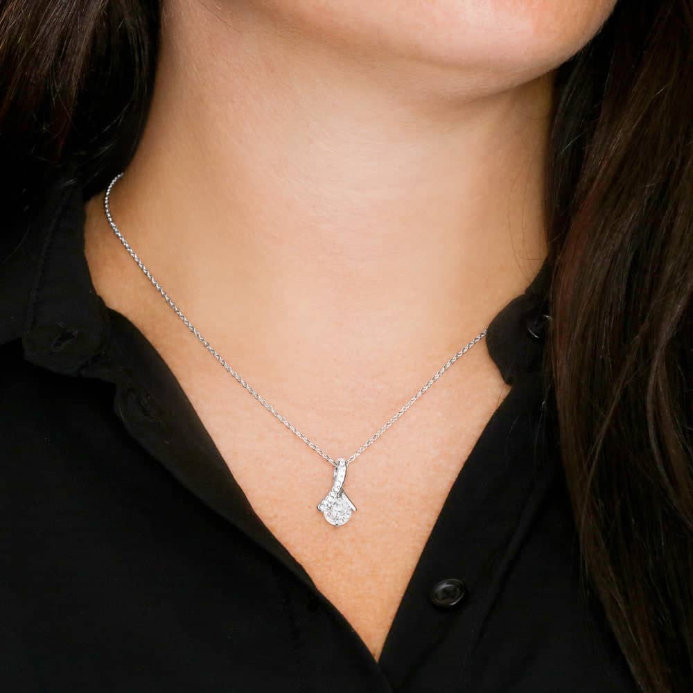 A woman wearing a Personalized Daughter Necklace with a cubic zirconia pendant.