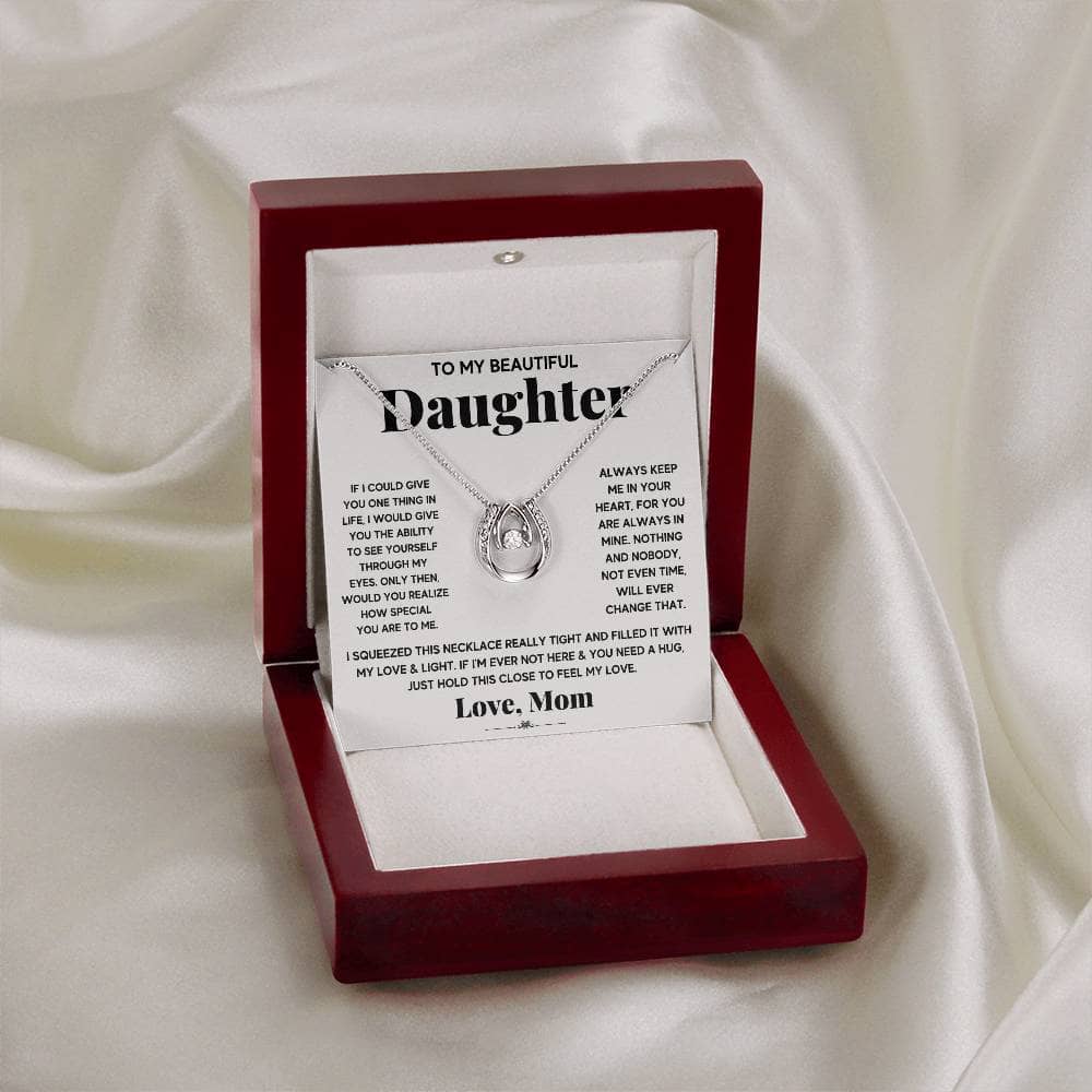 A personalized daughter necklace with a cushion-cut cubic zirconia pendant in a box.