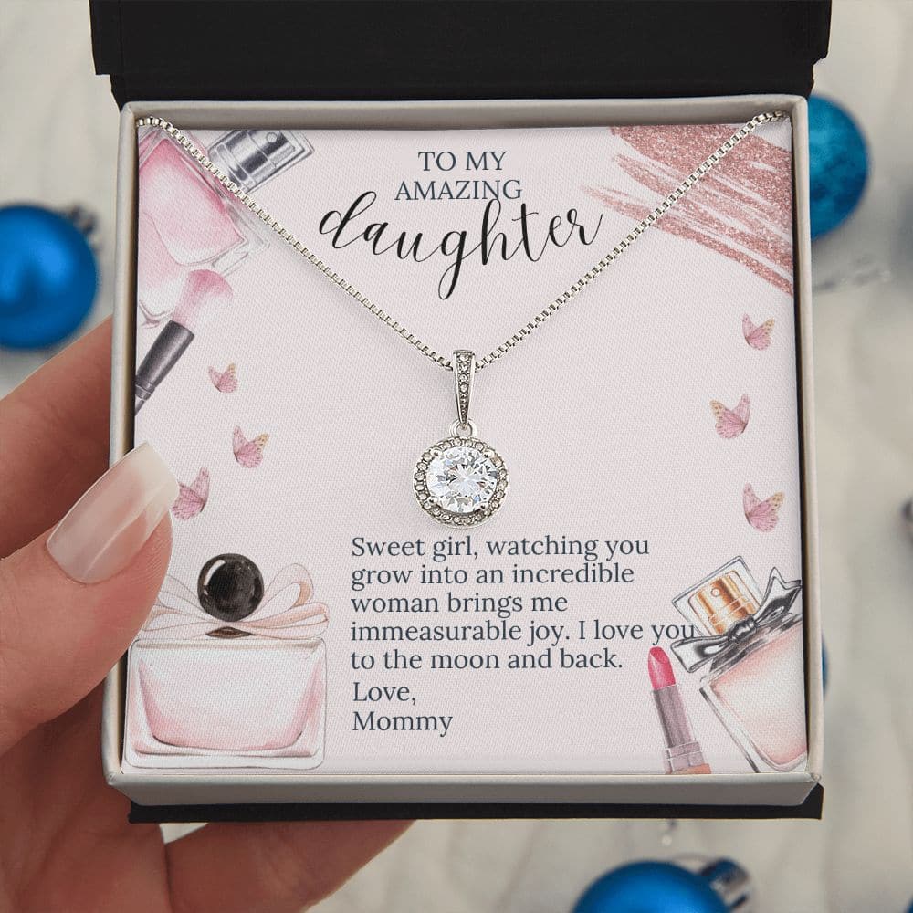 Alt text: "Personalized Daughter Necklace - A hand holding a necklace in a box, symbolizing the eternal bond between a mother and her daughter."