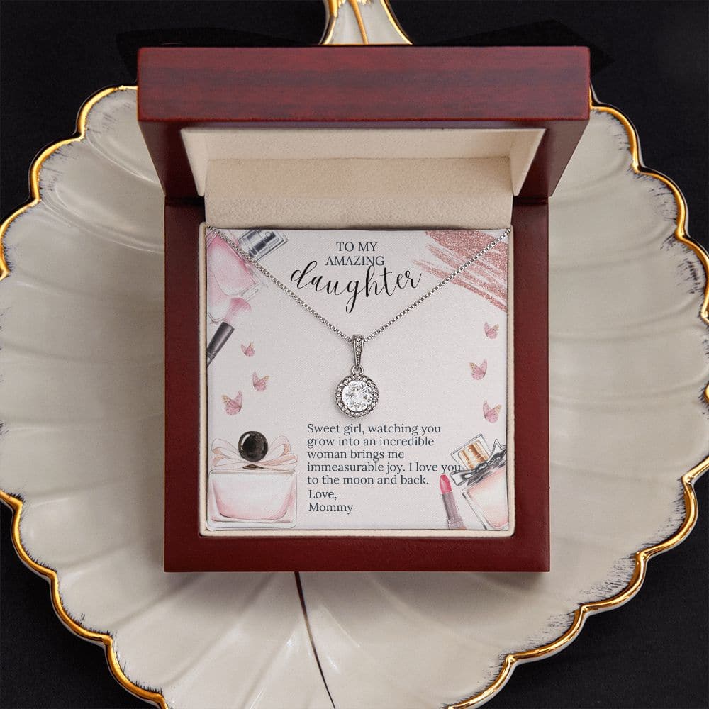 Alt text: "Forever Beloved Necklace - A necklace in a box on a plate, featuring an exquisite 8mm cushion-cut zirconia crystal. Symbolizes the eternal bond between a mother and her daughter. Personalized Daughter Necklace with Elegance."