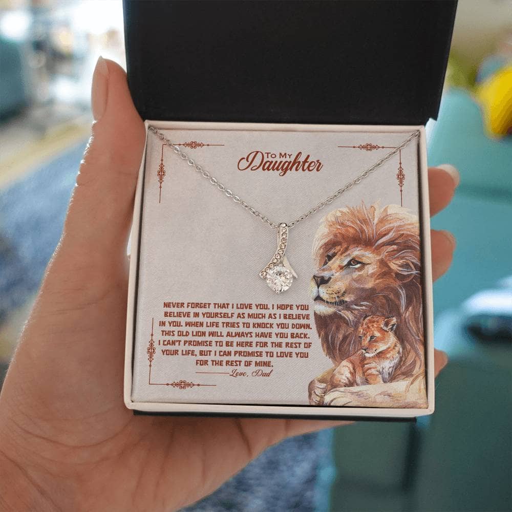 Alt text: "A hand holding a personalized daughter necklace in a luxurious box with LED lighting."