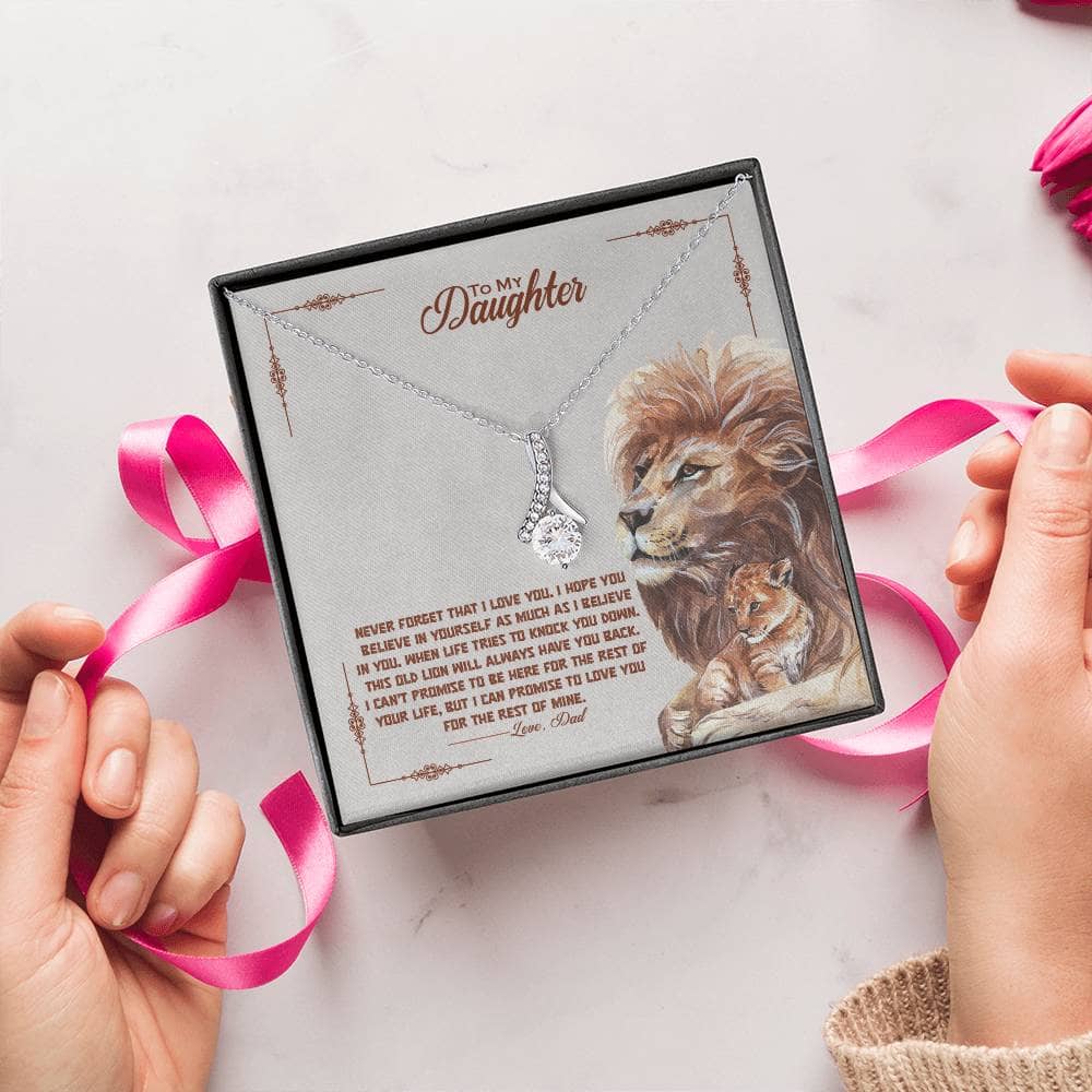 Alt text: "Hands holding a personalized Daughter Necklace with a lion and cat pendant, symbolizing enduring love and connection."