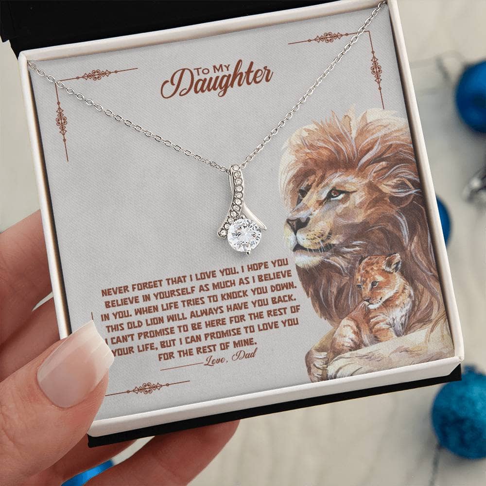 Alt text: "A hand holding a personalized daughter necklace in a luxurious box with LED lighting."