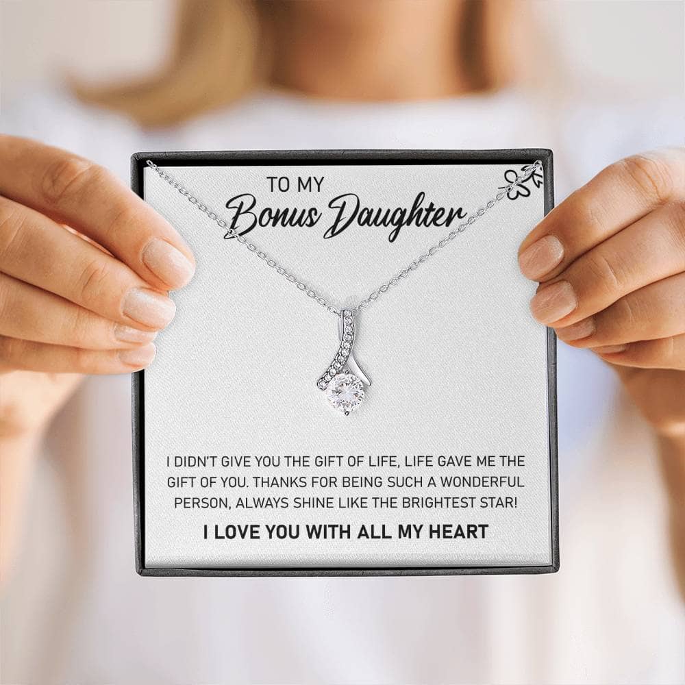 Alt text: "A person holding a heart-shaped pendant necklace with adjustable chains, symbolizing the unbreakable bond between parents and daughters."