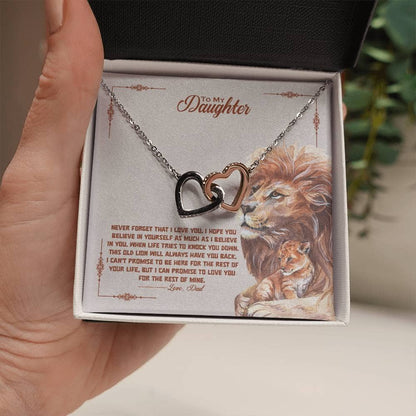 Alt text: "Interlocking Hearts necklace with cubic zirconia crystals, symbolizing the unbreakable bond between a parent and child. Housed in a mahogany box with LED lighting."