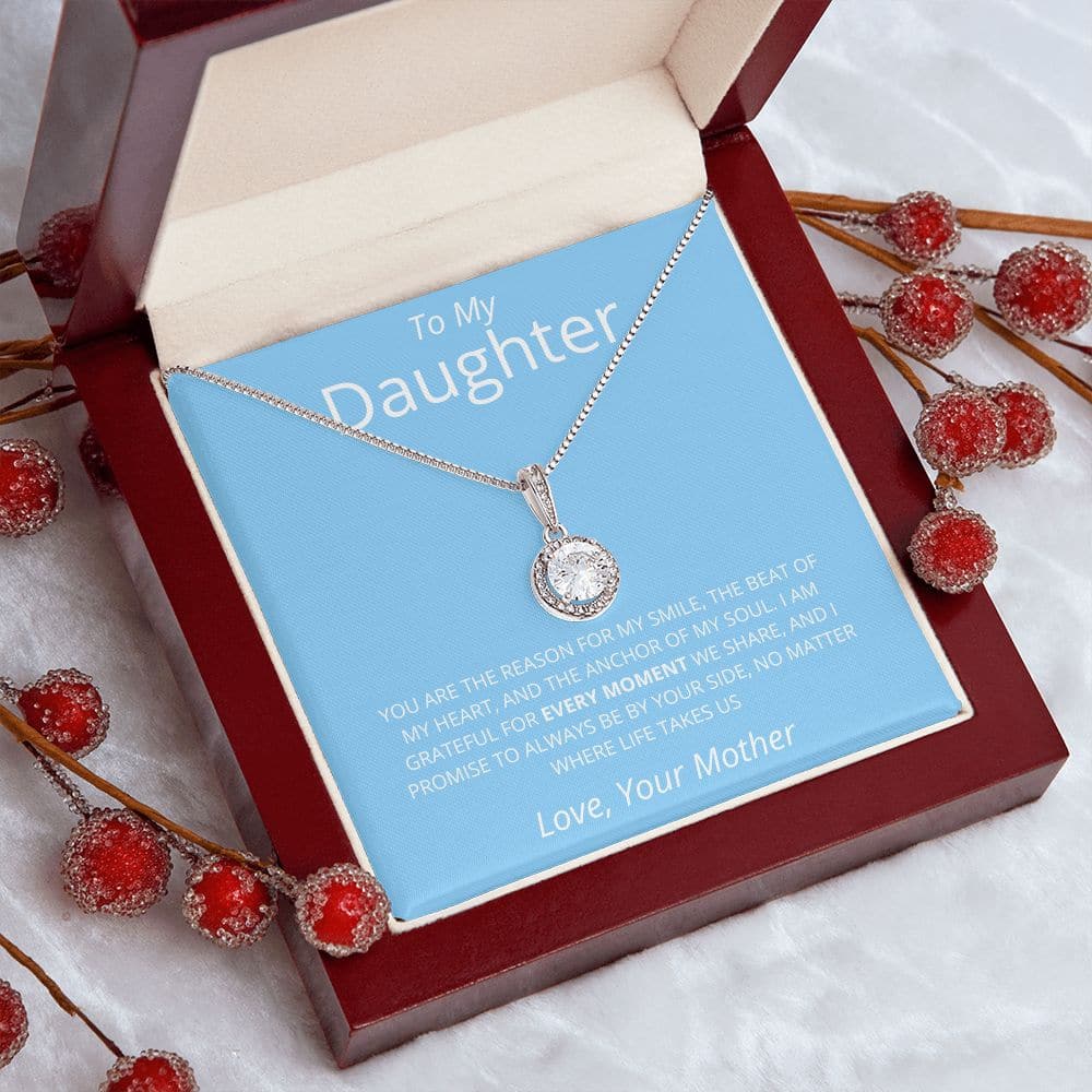A premium personalized daughter necklace with a heart-shaped pendant, adorned with cubic zirconia. Packaged in a mahogany-style box with LED lighting for an unforgettable unboxing experience.