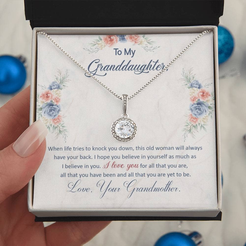 Alt text: "Personalized Granddaughter Eternal Hope Necklace - A hand holding a heart-shaped pendant in a box, symbolizing the enduring bond between grandparents and granddaughters."