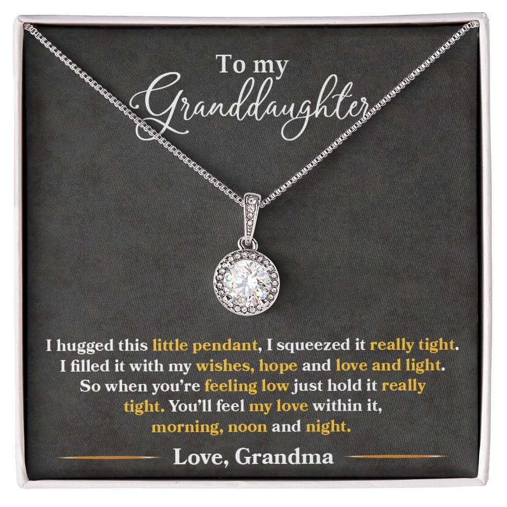 A close-up of the Personalized Granddaughter Heart Necklace, featuring a sparkling cushion-cut cubic zirconia pendant surrounded by accent CZ crystals. The necklace comes with an adjustable box chain and is packaged in a soft touch box for easy gifting.