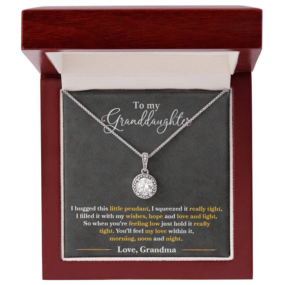 A close-up of the Personalized Granddaughter Heart Necklace, featuring a sparkling cushion-cut cubic zirconia crystal pendant on an adjustable box chain. A timeless and elegant gift for your loved one.