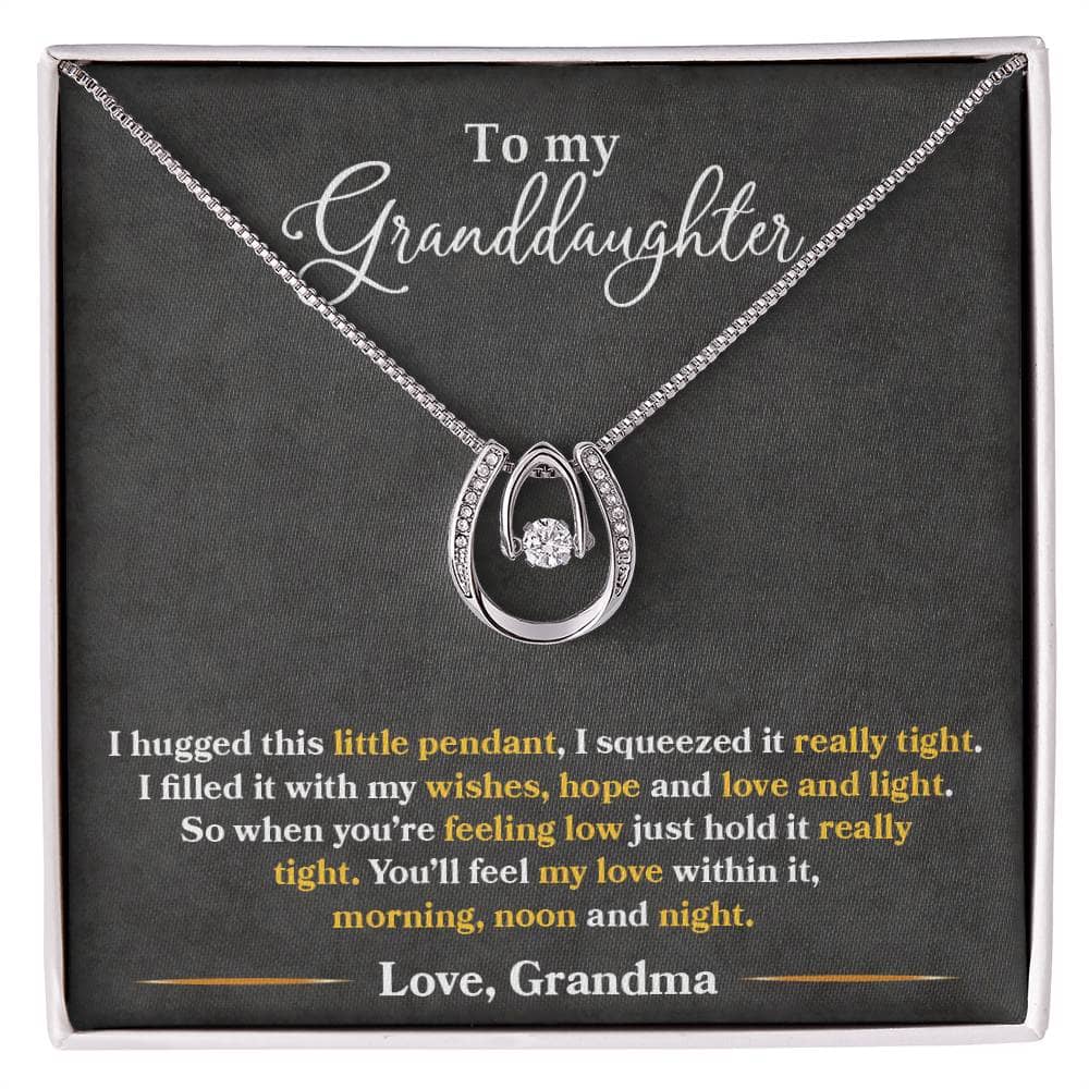 A necklace in a box, featuring a heart-shaped pendant symbolizing the immeasurable love between grandparents and granddaughters. Made with elite cubic zirconia, this Personalized Granddaughter Love Necklace offers timeless elegance and luxury. The adjustable chain provides personalized comfort, while the mahogany-style box adds a touch of magic to the unboxing experience. Perfect for treasured occasions, this necklace is a profound token of love.