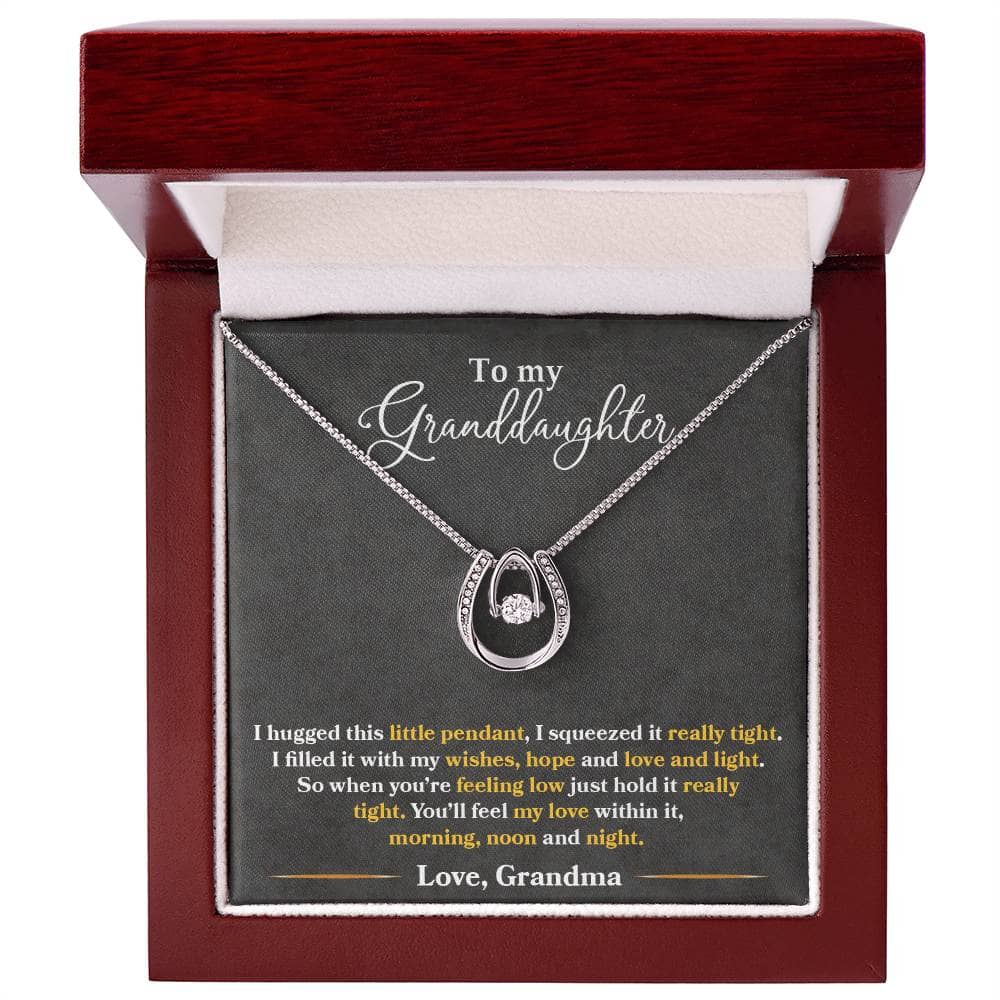 Alt text: "Personalized Granddaughter Love Necklace in a box, featuring a heart-shaped pendant and cubic zirconia center."