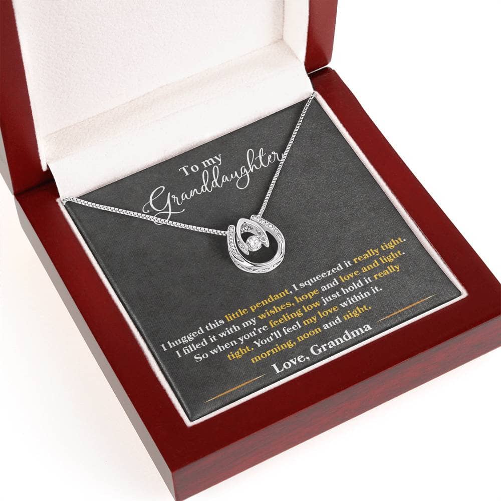 Alt text: "Close-up of Personalized Granddaughter Love Necklace in a box, featuring a heart-shaped pendant and cubic zirconia stones."