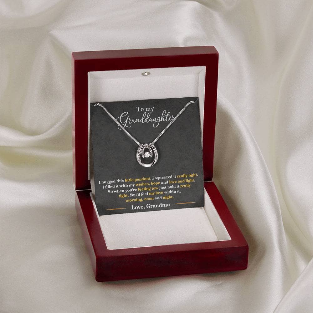 Alt text: "Personalized Granddaughter Love Necklace in a box, featuring a heart-shaped pendant with a diamond in the middle."