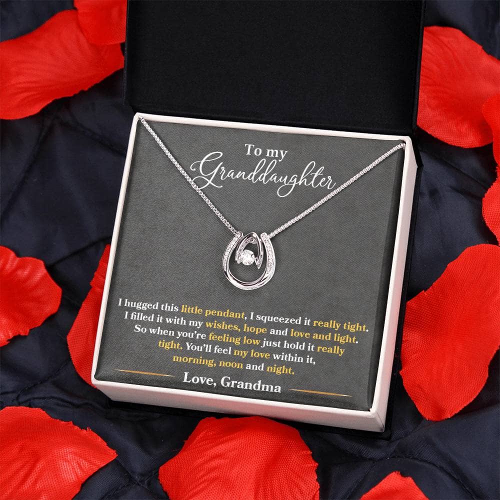 Alt text: "Personalized Granddaughter Love Necklace in a box on a blanket"