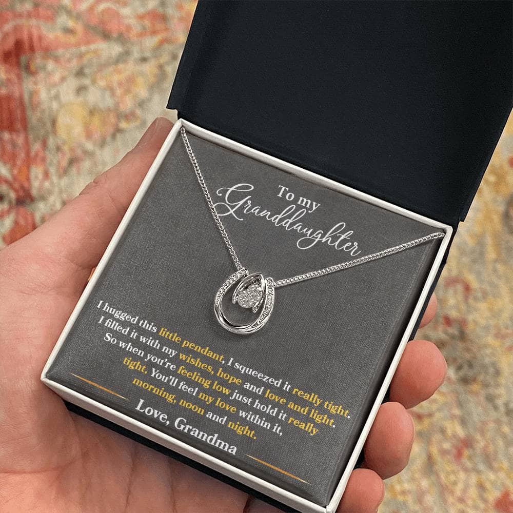 Alt text: "Hand holding Personalized Granddaughter Love Necklace in a box"