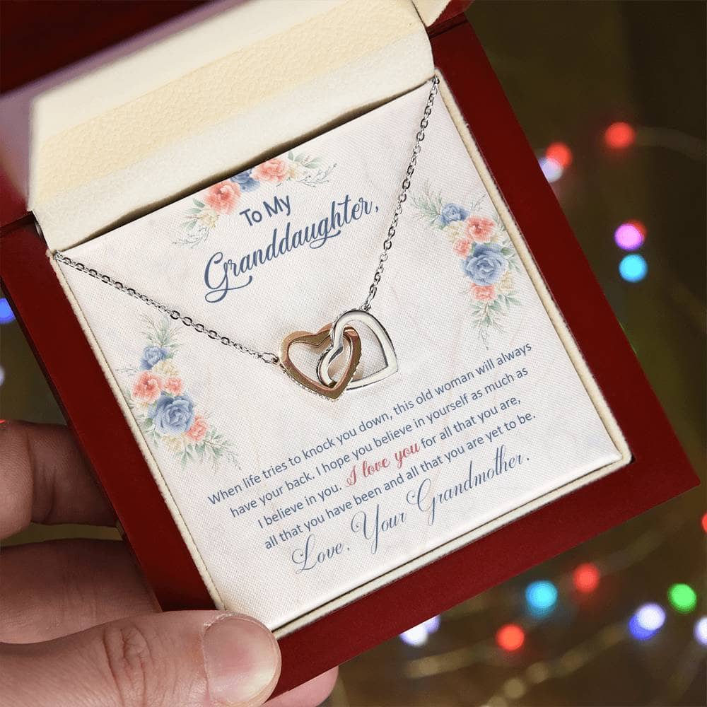 Alt text: "Hand holding Personalized Granddaughter Love Pendant in a box"
