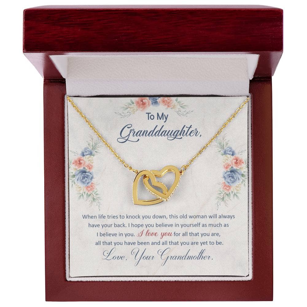 Alt text: "Personalized Granddaughter Love Pendant in a mahogany-styled box with LED lighting, showcasing a gold heart necklace."