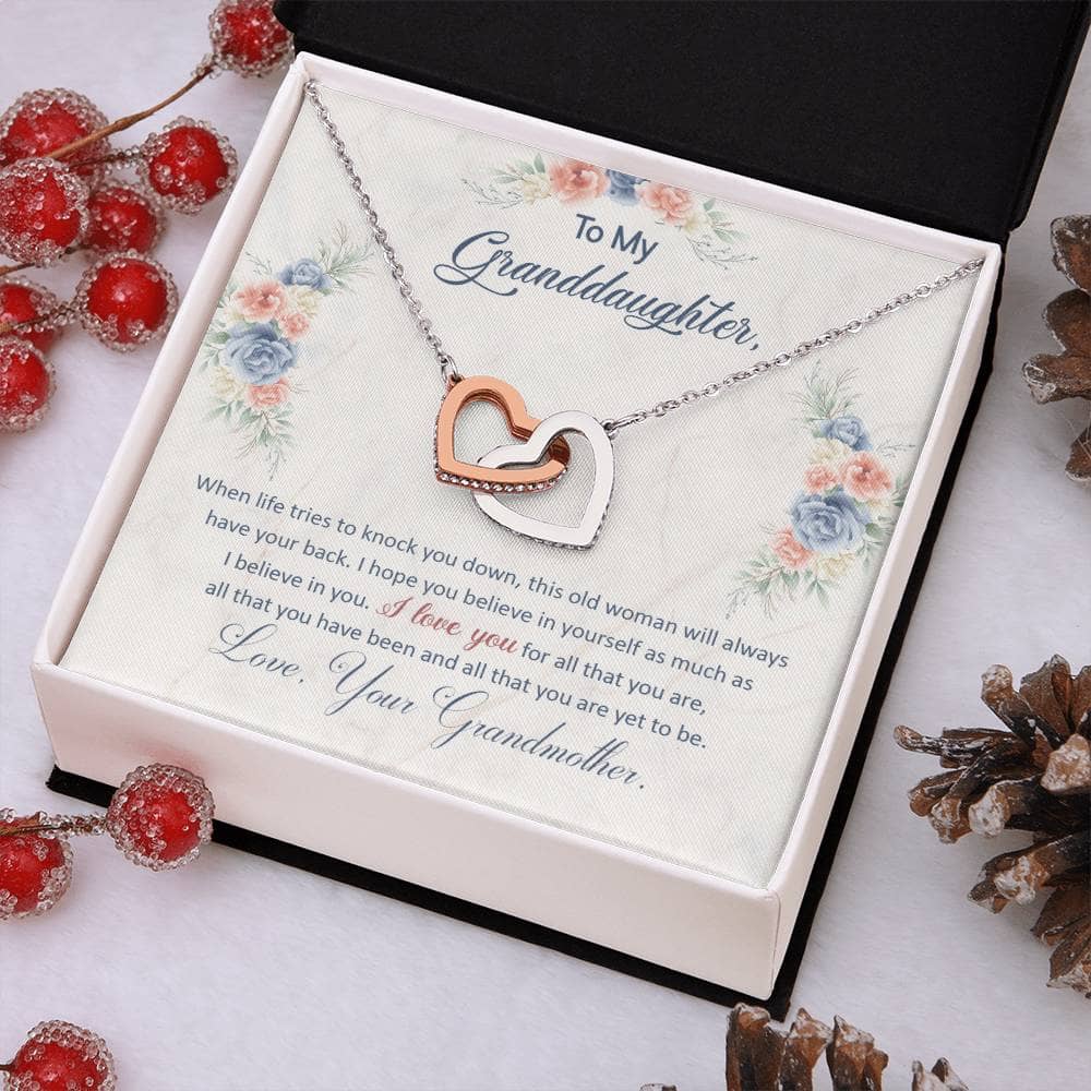 Alt text: "Personalized Granddaughter Love Pendant in a box with pine cones and berries"