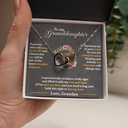 Alt text: "A hand holding a Personalized Granddaughter Love Token Necklace in a box"
