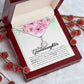 A necklace in a mahogany-style box with a note and berries, part of the Personalized Granddaughter Necklace - Eternal Hope Design collection.