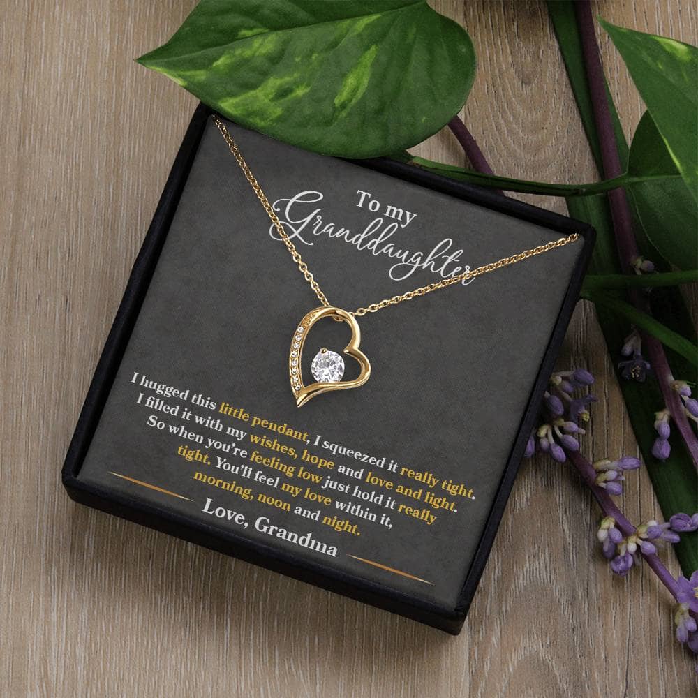 Alt text: "A necklace in a box with a heart-shaped pendant, part of the Personalized Granddaughter Necklace - Forever Love Token collection"