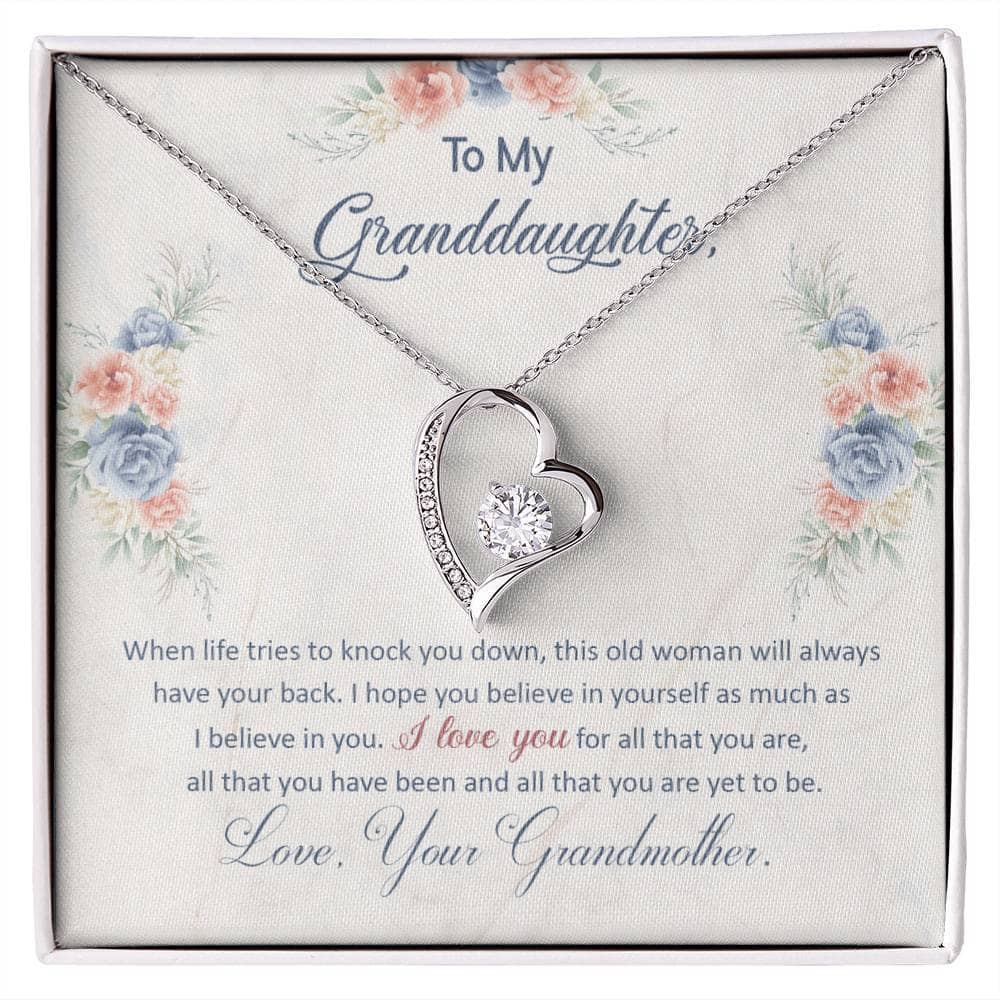 A close-up image of a Personalized Granddaughter Necklace in a box. The necklace features a heart-shaped pendant with a diamond in the center. The necklace is crafted with premium materials and comes with an adjustable chain. It is packaged in a luxury box with LED lighting.
