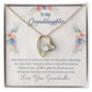 A necklace in a box featuring a gold heart with a diamond. Personalized Granddaughter Necklace of Love, crafted with premium materials and a symbol of the deep bond between grandparents and granddaughters. Adjustable chains for comfort and versatility. Packaged in a luxury box with LED lighting.