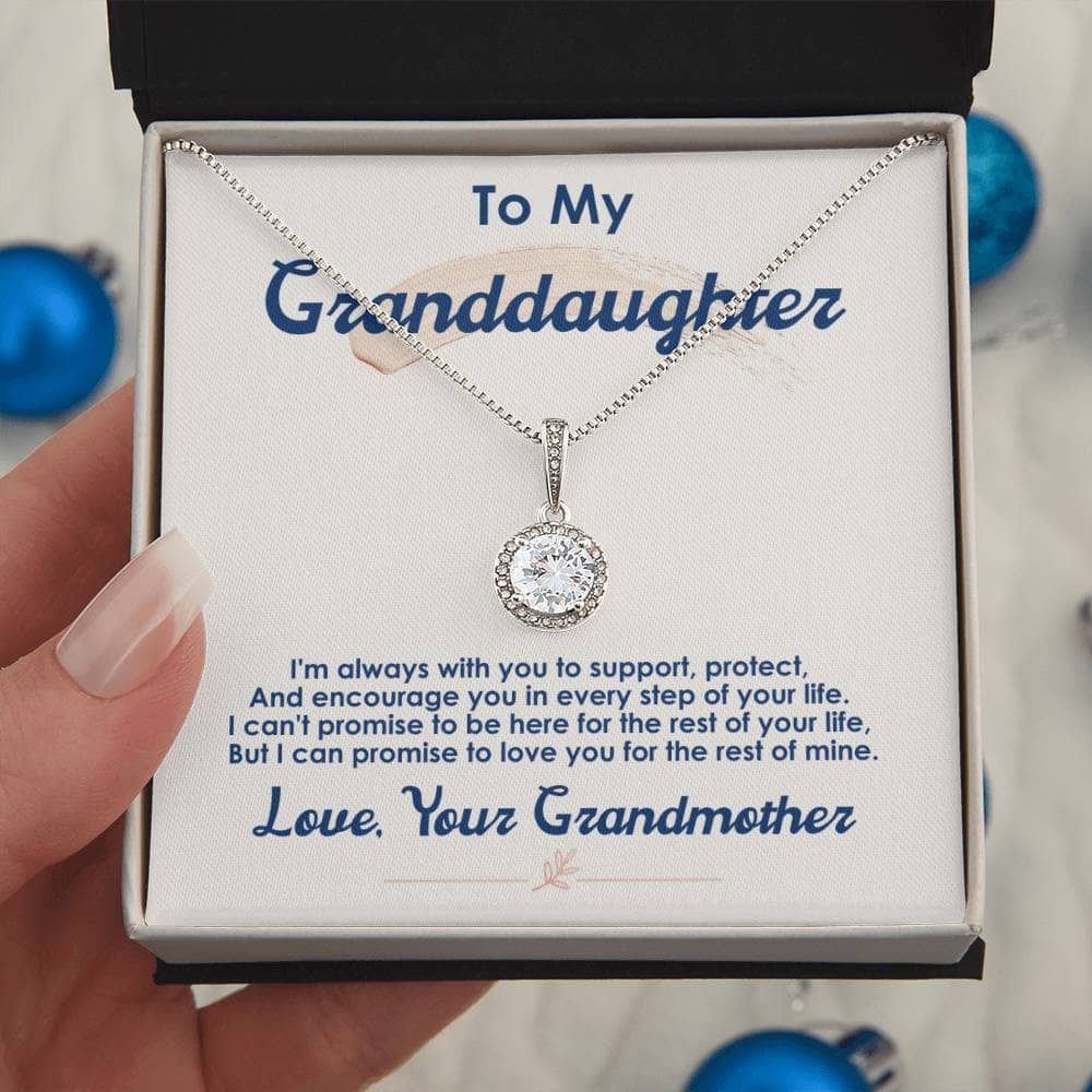 A hand holding a Personalized Granddaughter Necklace with Cubic Zirconia, nestled in a luxurious box.