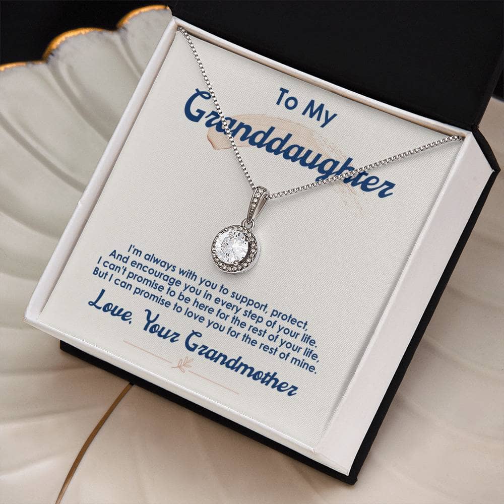 A close-up image of the Personalized Granddaughter Necklace with Cubic Zirconia, featuring a heart-shaped pendant adorned with a cushion-cut cubic zirconia crystal. The necklace is elegantly displayed in a mahogany-style box with LED lighting, ready to be gifted.