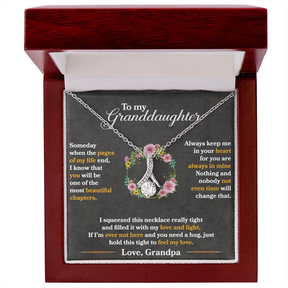 Alt text: "Personalized Granddaughter's Embrace Necklace in a mahogany-style box with LED lighting"