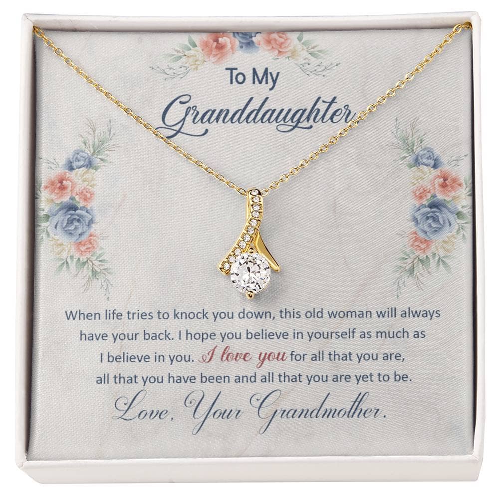 Alt text: "Personalized Keepsake Necklace for Granddaughter - A necklace in a box with a close-up of a diamond and a gold and diamond ring."