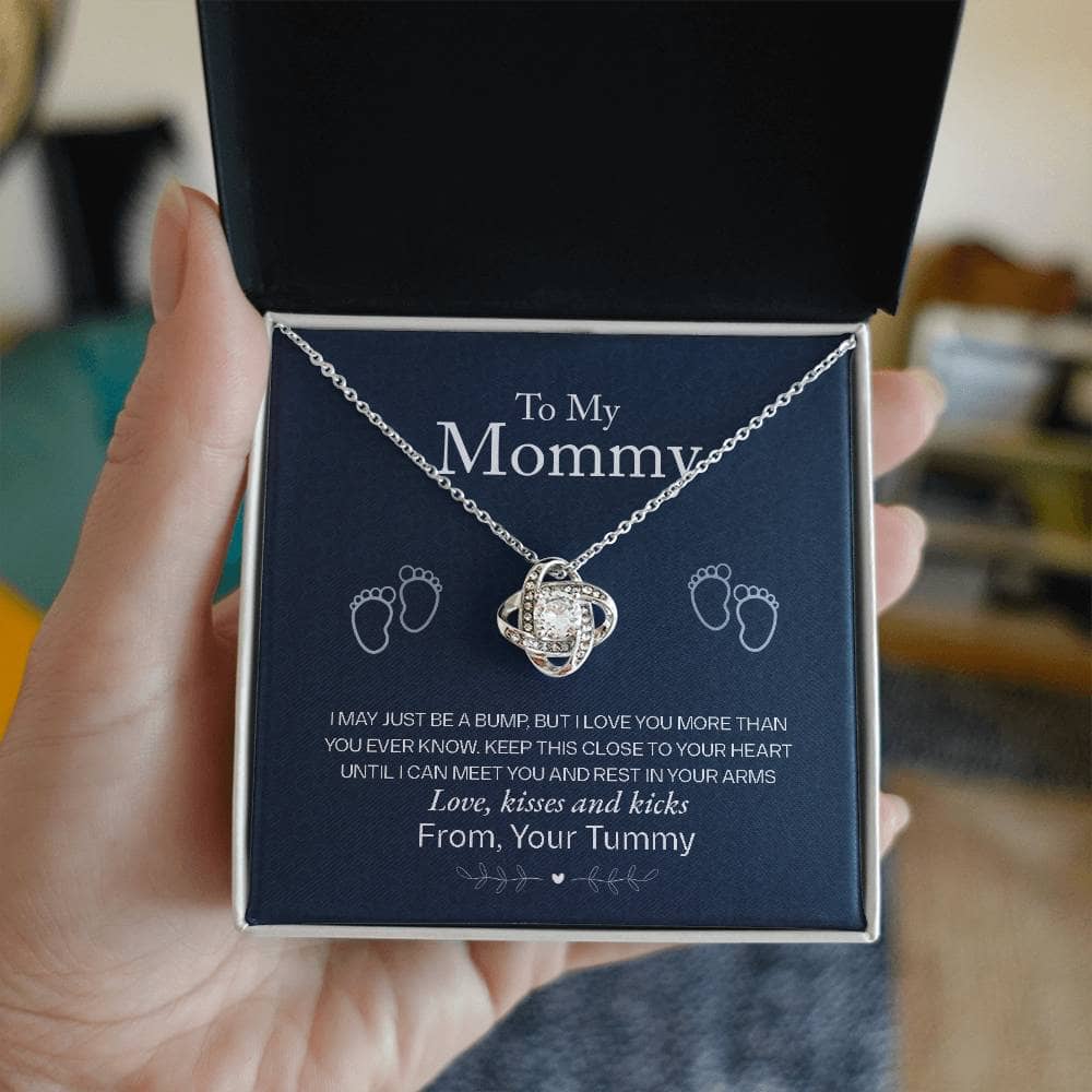 A hand holding a Personalized Mother Necklace in a box, symbolizing the unbreakable bond between mothers and their children.