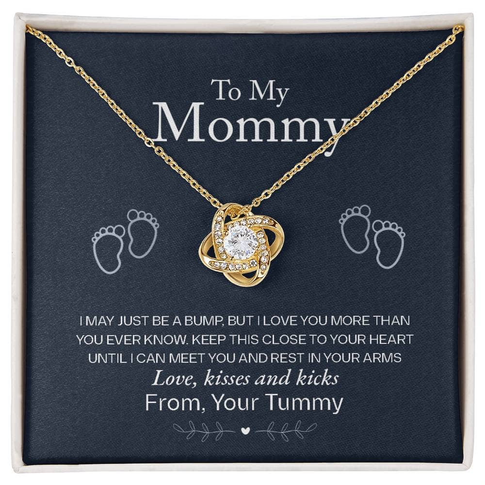 A gold necklace with a diamond pendant in a box, symbolizing the unbreakable bond between mothers and children.