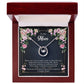 A necklace in an elegant mahogany-style box, perfect for gifting.