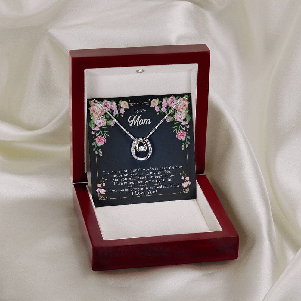 A gift box with a personalized mother necklace inside, featuring a heart-shaped pendant and a radiant cubic zirconia. The necklace comes in an elegant mahogany-style box with LED lighting for a magical unboxing experience.