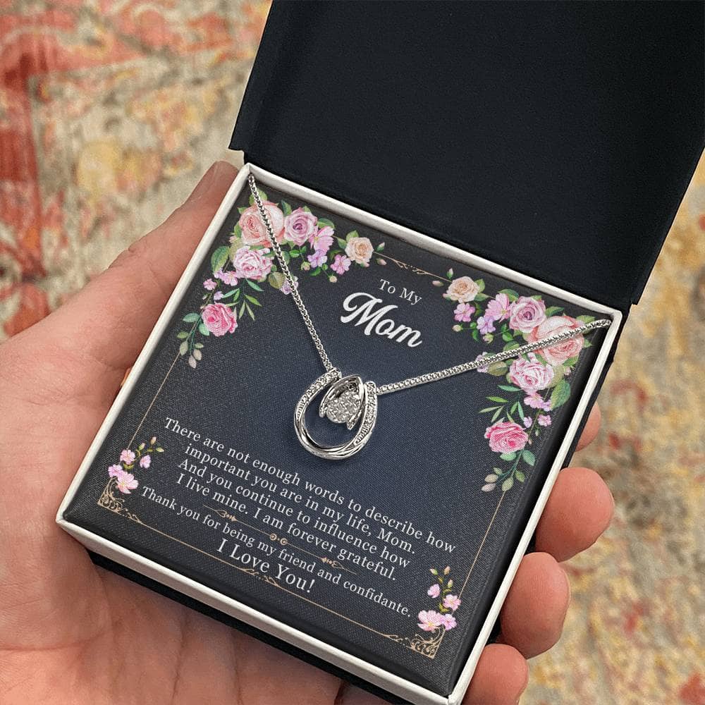 Alt text: "Hand holding Personalized Mother Necklace in elegant box"