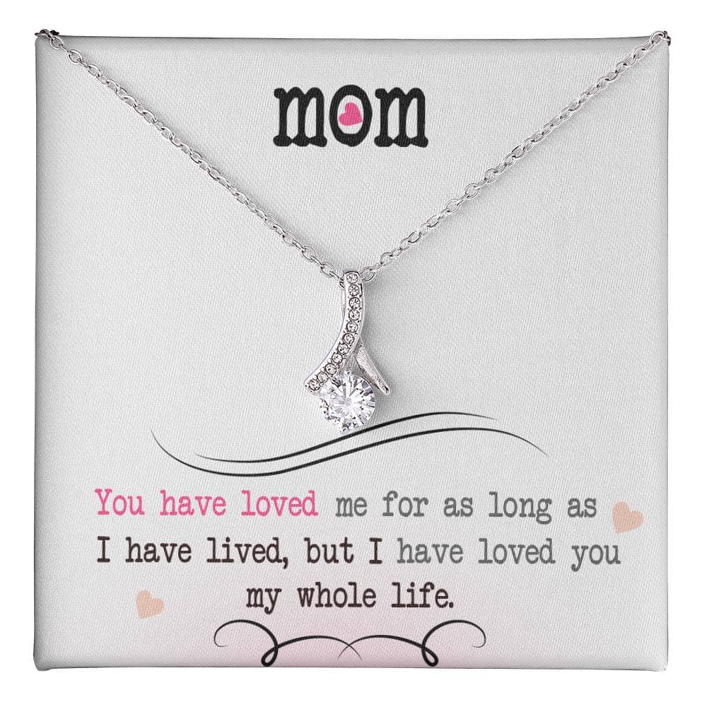Alt text: "Close-up of Personalized Mother Necklace with heart-shaped pendant on white box"