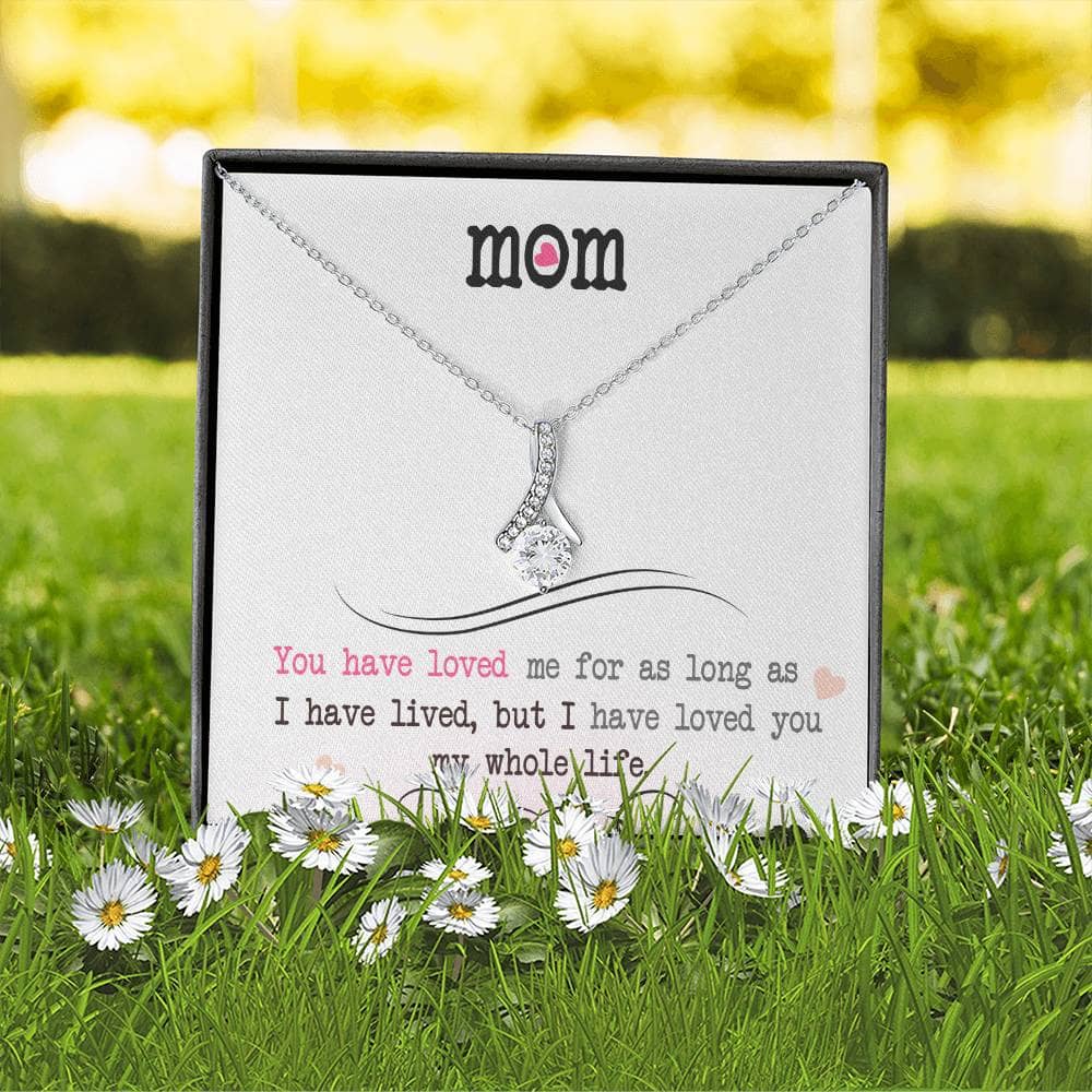 A necklace in a box with a heart-shaped pendant, symbolizing the unconditional love between a mother and child.