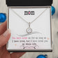 A hand holding a Personalized Mother Necklace in a box, symbolizing the everlasting bond between a mother and her child.