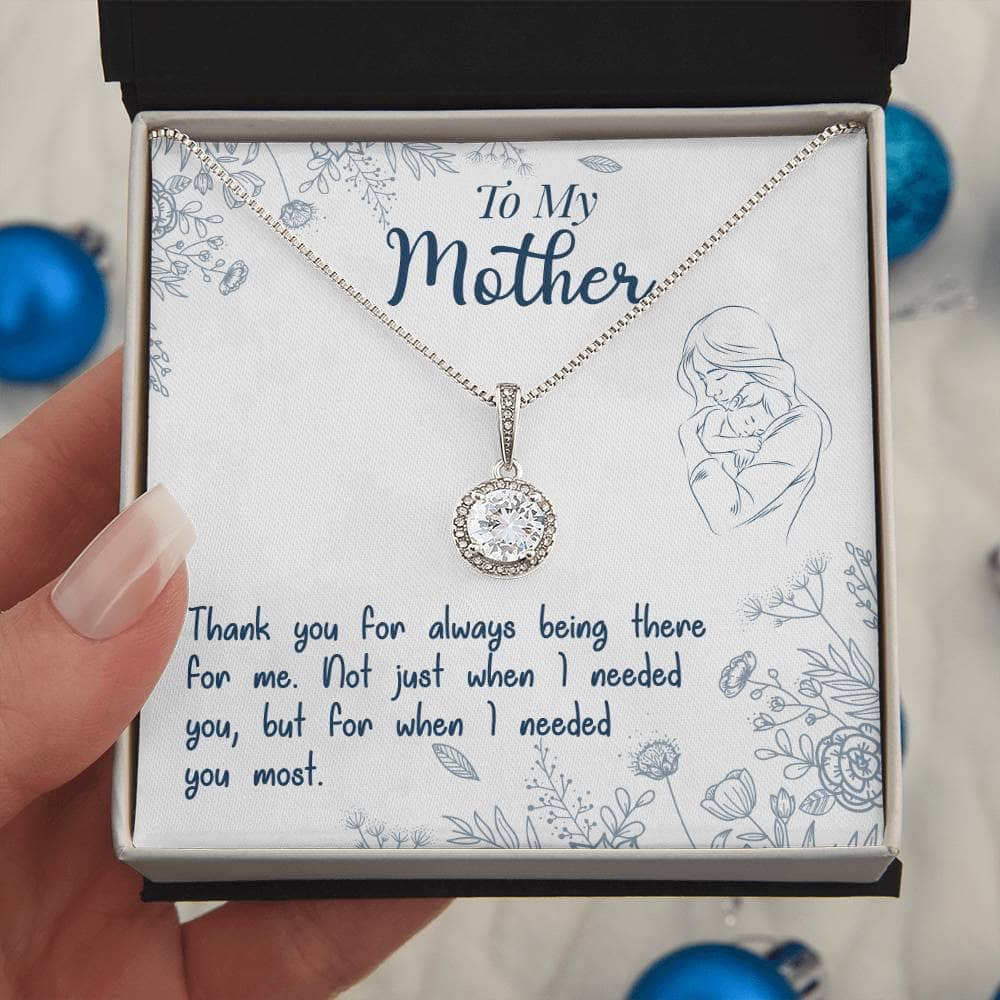 Alt text: "A hand holding a personalized Mother Necklace in a box, featuring a heart-shaped pendant with a Luxurious Cushion-Cut Cubic Zirconia stone, symbolizing the strength of maternal love."