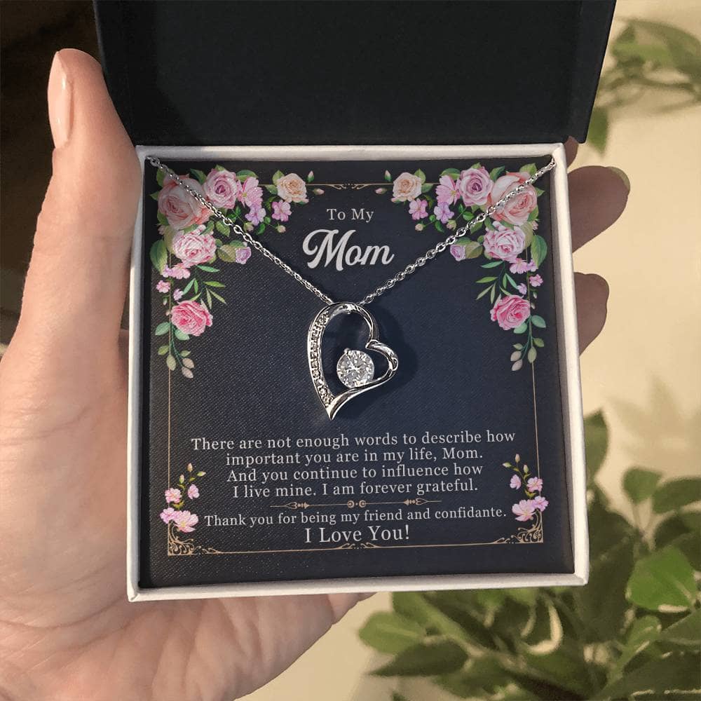 Alt text: "A hand holding a heart-shaped pendant necklace in a box - Personalized Mother Necklace - Forever Love Pendant Gift"