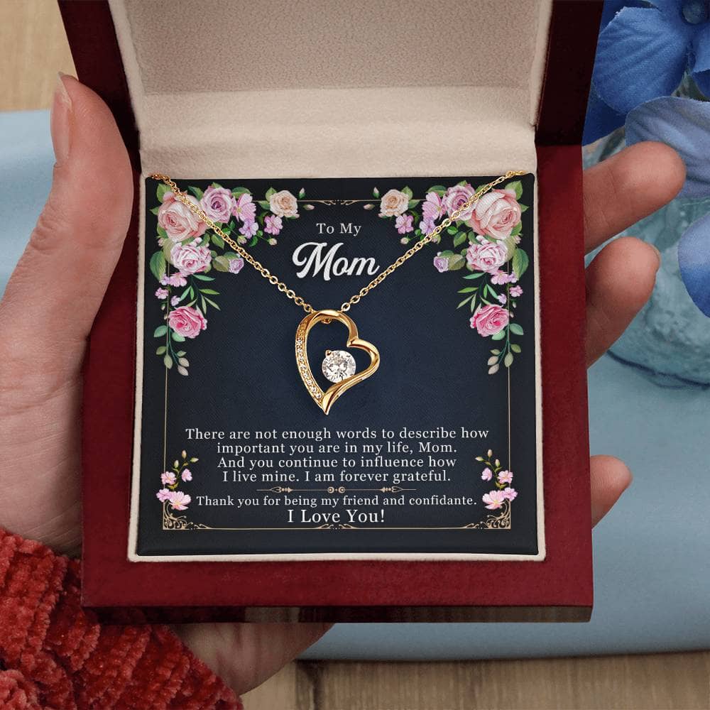 Alt text: "A hand holding a heart-shaped pendant necklace in a box, symbolizing forever love. Personalized Mother Necklace - Forever Love Pendant Gift."