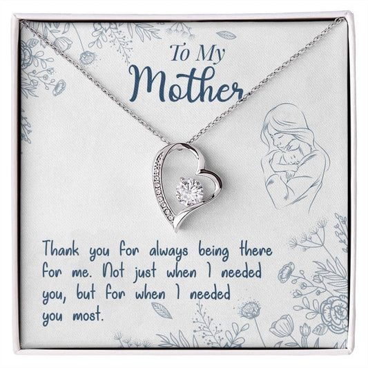 A necklace with a heart-shaped pendant in a box, part of the Personalized Mother Necklace Collection. Symbolize the unbreakable bond between a mother and child with this elegant piece. Perfect for daily wear or special occasions. Packaged in a luxurious LED lit mahogany-style box.