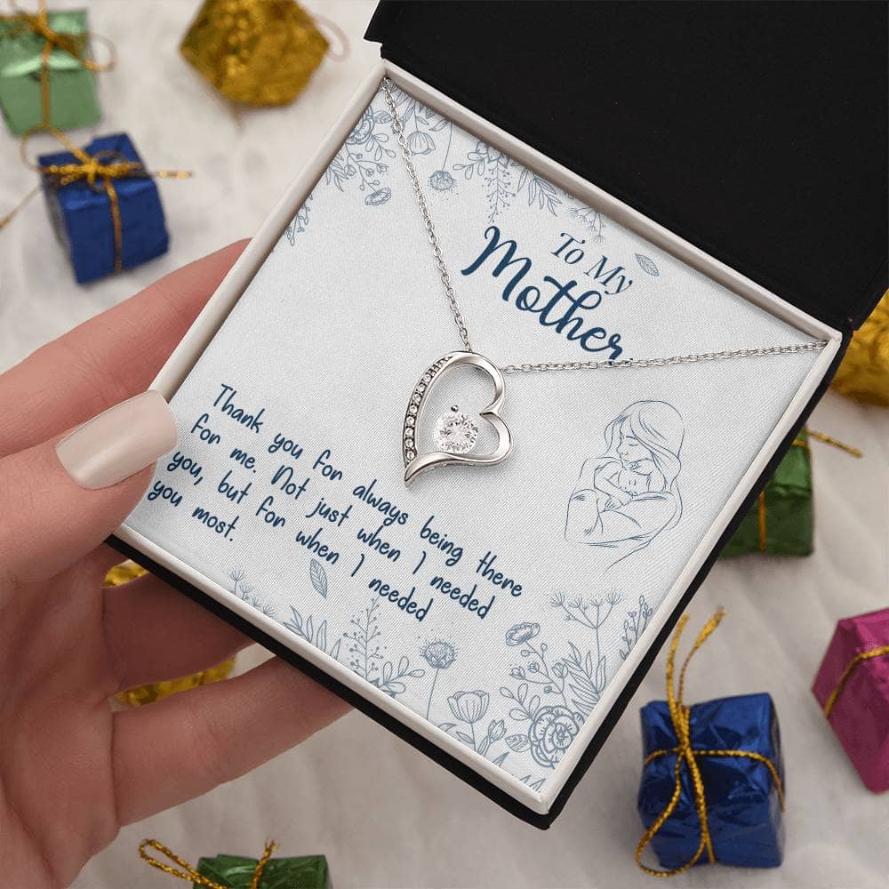 Alt text: "A hand holding a Sparkling Personalized Mother Necklace in a luxurious gift box"